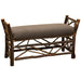 Fireside Lodge Hickory Log Bedside Bench with Twig Accent is a rustic hickory log bench with twig detailing and a cushioned brown seat