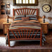 Fireside Lodge Hickory Log Sunburst Bed styled in a rustic bedroom, fully made with bedding, nightstands, lamps, and wall décor to show how it looks in a real room
