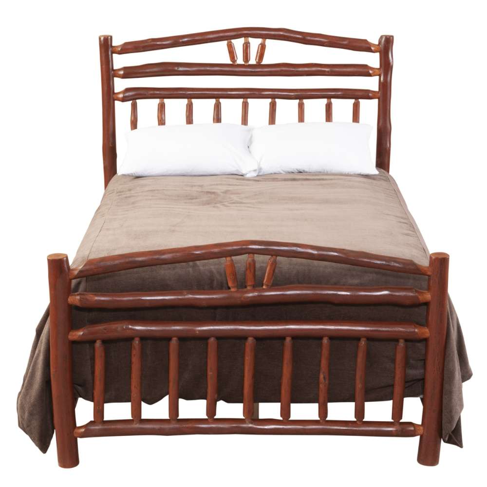 Fireside Lodge Hickory Log Wagon Wheel Bed is shown from the front with bedding, emphasizing the tall curved log headboard