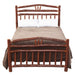Fireside Lodge Hickory Log Wagon Wheel Bed is shown from the front with bedding, emphasizing the tall curved log headboard