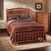 Fireside Lodge Hickory Log Wagon Wheel Bed is shown in a rustic bedroom with a curved hickory log headboard and footboard