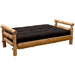 Fireside Lodge Voyageur Futon laid flat into a bed-like position with a black mattress resting on a natural log frame