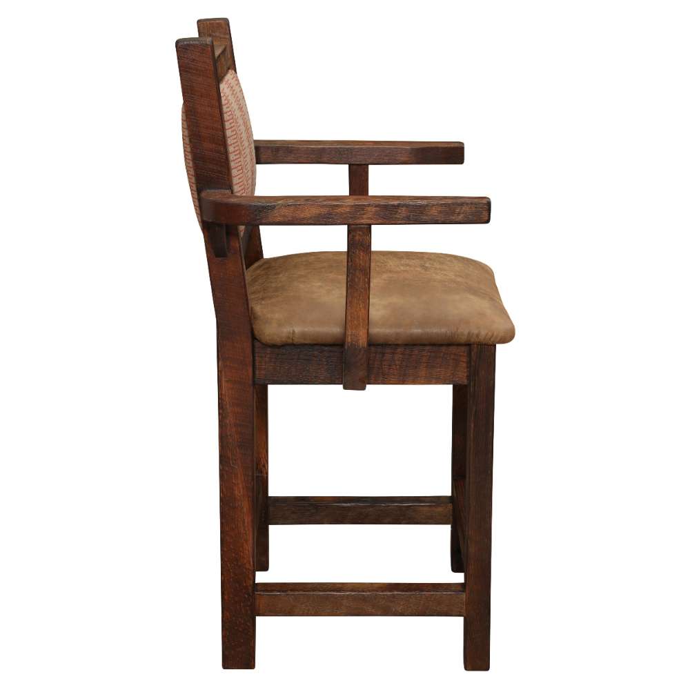 Fireside Lodge Barnwood Colonial Counter Stool with Arms shows a side profile highlighting its sturdy armrests, thick wooden legs, and padded leather-style seat