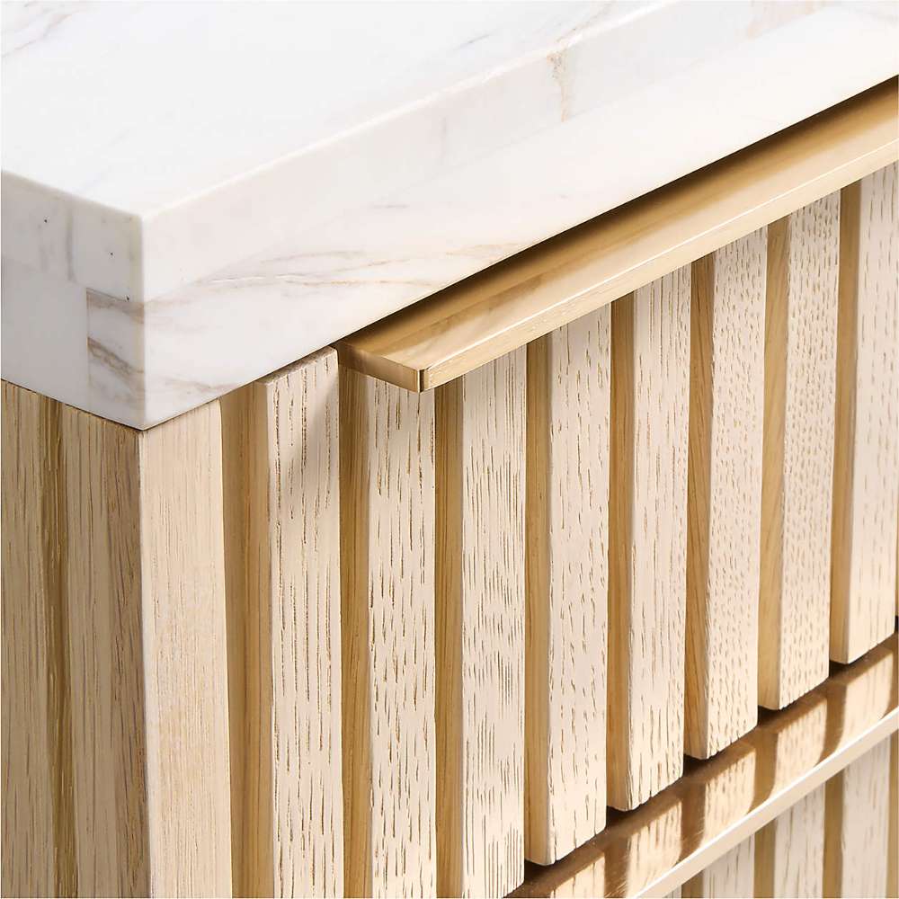 Fluted white oak drawer fronts and brass pulls on Crate & Barrel Batten 62" White Oak Wood Console Desk with White Marble Top