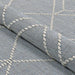 Folded view of Couristan Liguria Indoor/Outdoor Rug - Noli/Azul emphasizes its flexible material and raised geometric patterns