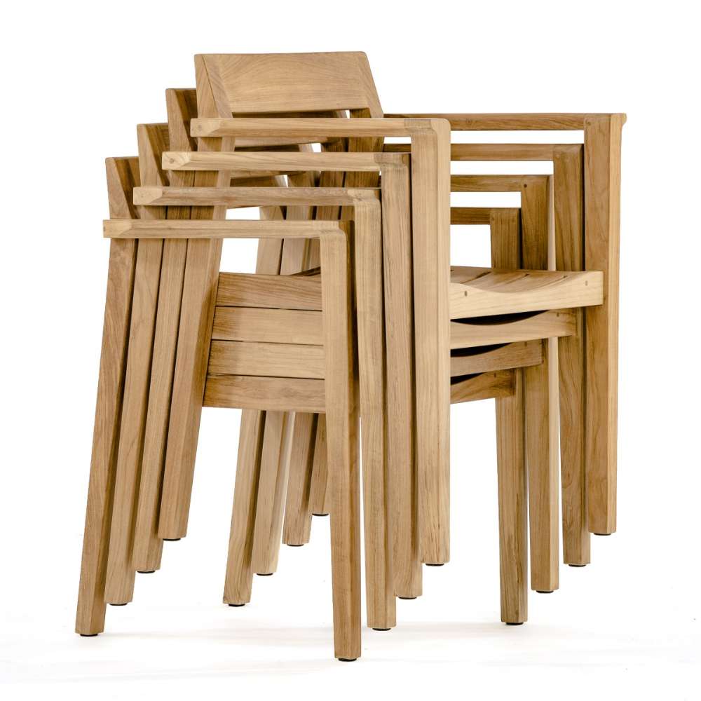 Four Westminster Teak Horizon Teak Dining Armchairs are stacked neatly together, showing their space-saving design and uniform shape