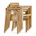 Four Westminster Teak Horizon Teak Dining Armchairs are stacked neatly together, showing their space-saving design and uniform shape