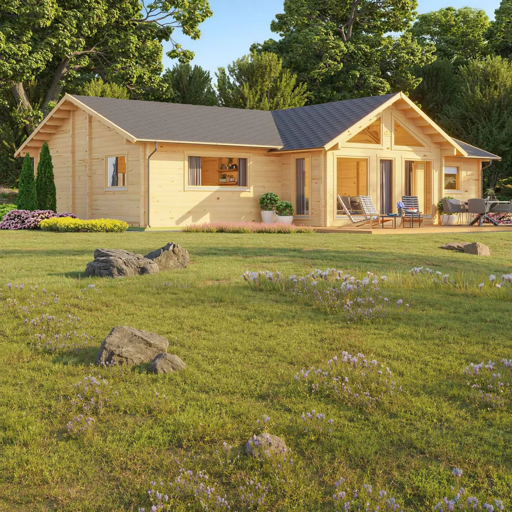 Front-angle view shows the GardenHouse24 USA Francesca 70 Garden Room with a wide deck, lounge chairs, potted plants, and vibrant landscaping
