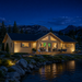 Francesca 70 glowing beside a Wyoming alpine lake while family and friends watch sports inside.