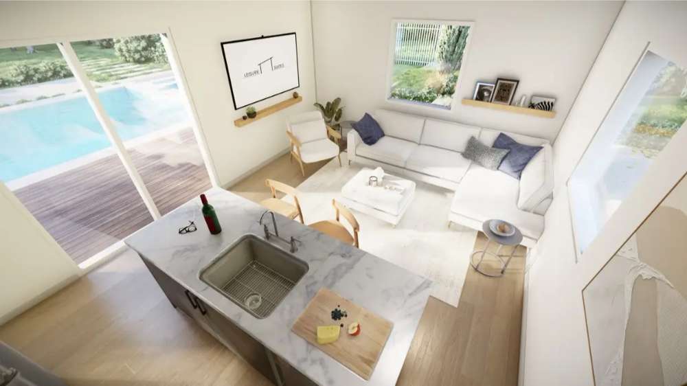 From above, Sawmill Structures The Banff Garden Suites shows a bright living space with a white sectional couch, marble island, and views of a private pool