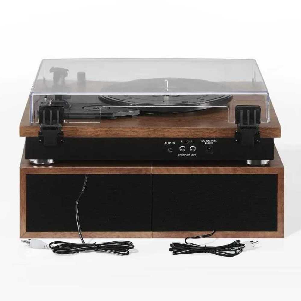 From the back, the Crosley Riff Record Player With Speakers - Walnut reveals aux input ports, speaker output, and power connections