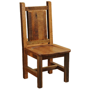 Front angled view of Fireside Lodge Barnwood Artisan Dining Side Chair showing a rustic solid wood frame, plank backrest, and carved wooden seat