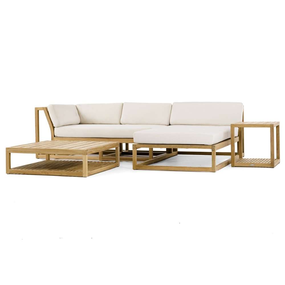 Front-angled view of Westminster Teak Maya 4pc Lounge Set showing a teak sectional sofa, chaise lounge, coffee table, and side table with light cushions on a white background