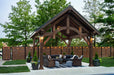 Front view of Brookside Timber Frame Alpine Lodge Pavilion showcases its intricate wooden structure and lantern-style lighting