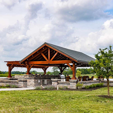 Front view of Brookside Timber Frame Combolan Estate Pavilion showcases its high-quality timber construction, a stylish metal roof, and an inviting outdoor kitchen setup