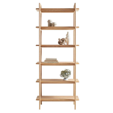 Front view of Crate & Barrel Elias Natural Elm Wood Open Bookcase styled with books, vases, and small decorative objects on its six shelves