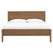 Front view of Crate & Barrel Keane Solid Driftwood King Bed showing the paneled headboard, footboard, and crisp white bedding