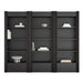 Front view of Crate & Barrel Siena 102" Black Wood 4-Shelf Storage Bookcase with Drawer, Set of 3 styled with books and decorative accents across twelve open shelves