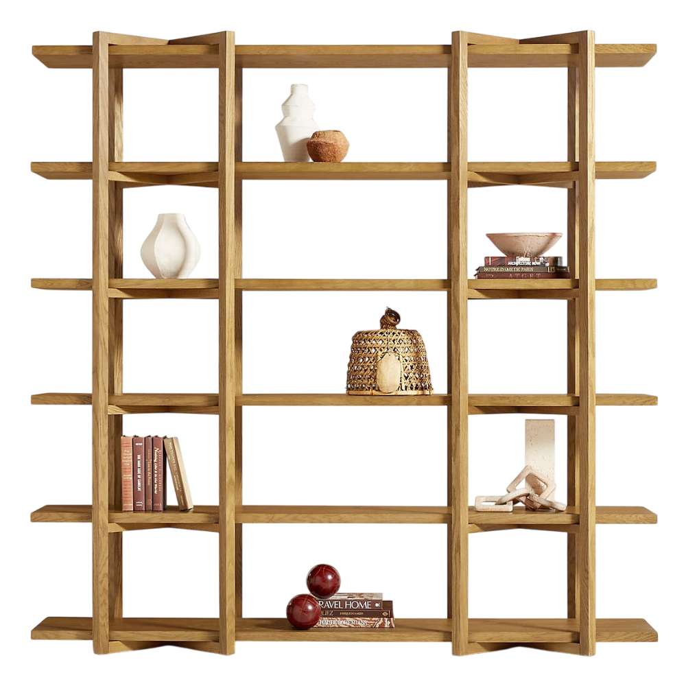 Front view of Crate & Barrel Thomas Barley Oak Wood Wide Open Bookcase/Room Divider decorated with books, pottery, and decorative objects across its open shelves