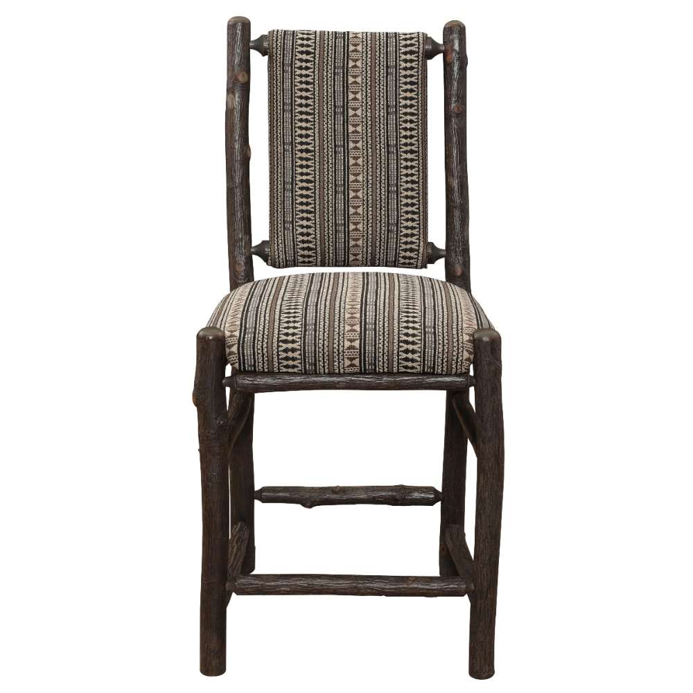 Front view of Fireside Lodge Hickory Log Upholstered Counter Stool shows sturdy log legs, footrest bars, and a padded southwestern-style upholstered seat and back