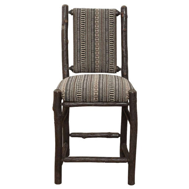 Front view of Fireside Lodge Hickory Log Upholstered Counter Stool shows sturdy log legs, footrest bars, and a padded southwestern-style upholstered seat and back