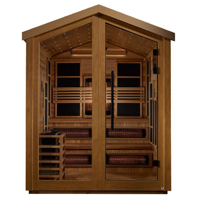 Front view of Golden Designs Kaskinen 6 Person Barn Hybrid Outdoor Sauna showing a peaked roof, glass double doors, star lights in the ceiling and glowing infrared heaters