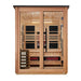 Front view of Golden Designs Loviisa 3 Person Pacific Cedar Barn Hybrid Outdoor Sauna showing a cedar exterior, double glass doors and glowing infrared heaters inside