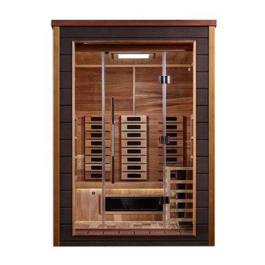 Front view of Golden Designs Nora 2 Person Outdoor-Indoor PureTech Hybrid Full Spectrum Sauna showing a dark exterior, glass door, carbon panels and a guarded stove beside the bench
