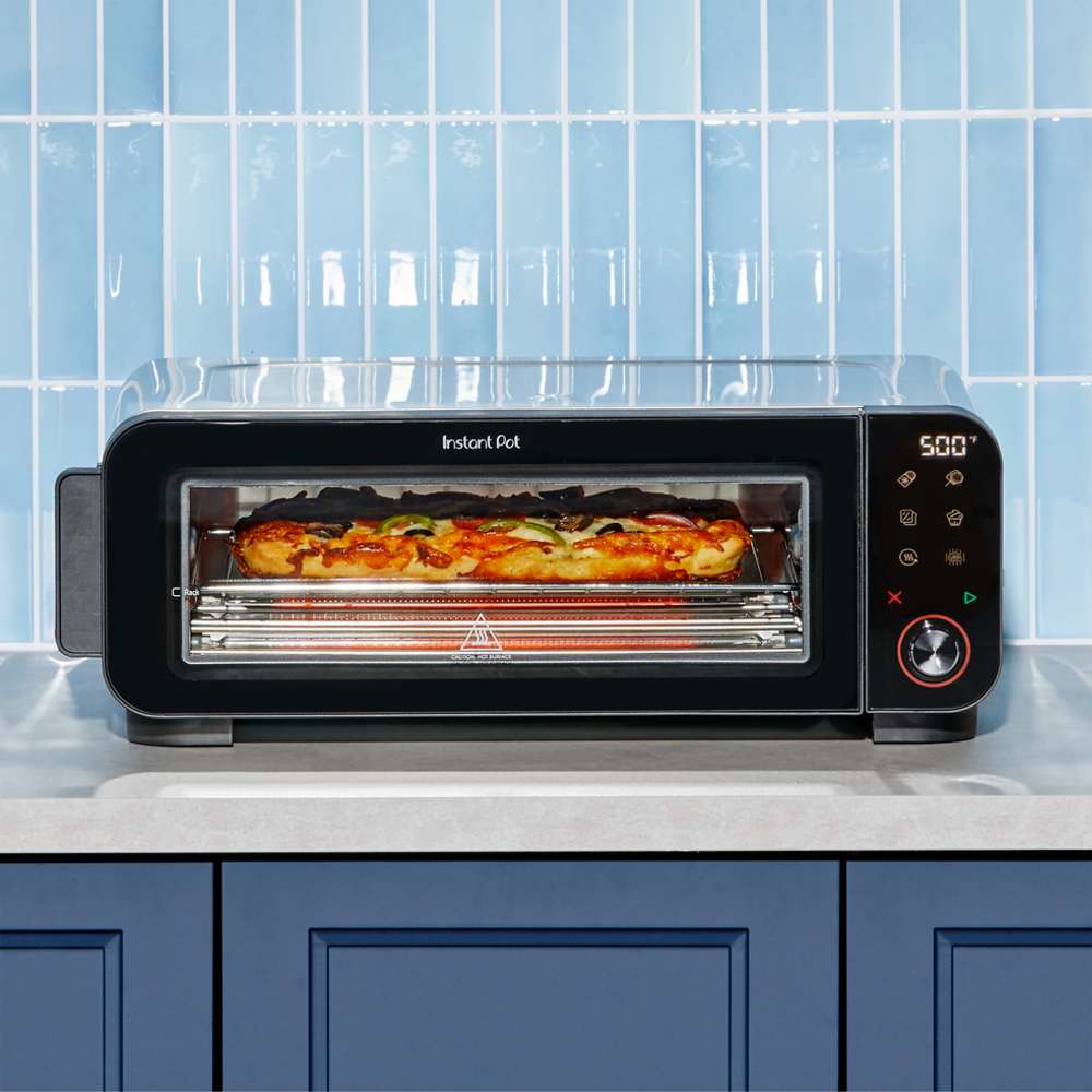 Front view of Instant Pot® InstantHeat™ Pizza Oven cooking a pizza at 500°F on a kitchen countertop