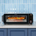 Front view of Instant Pot® InstantHeat™ Pizza Oven cooking a pizza at 500°F on a kitchen countertop