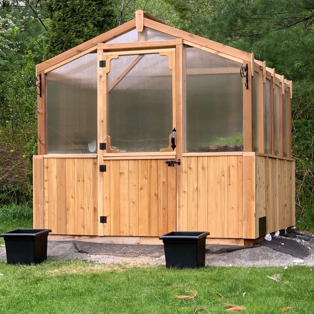 Front view of the greenhouse on grass shows the sturdy 8x8 Outdoor Living Today Western Red Cedar Greenhouse Kit