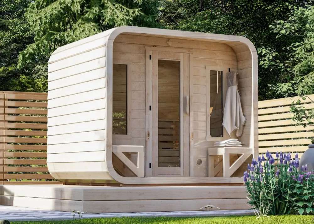 Front view of Sawmill Structures Box Sauna showcasing its cozy entrance with towels neatly placed on a wooden bench