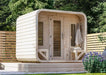 Front view of Sawmill Structures Box Sauna showcasing its cozy entrance with towels neatly placed on a wooden bench