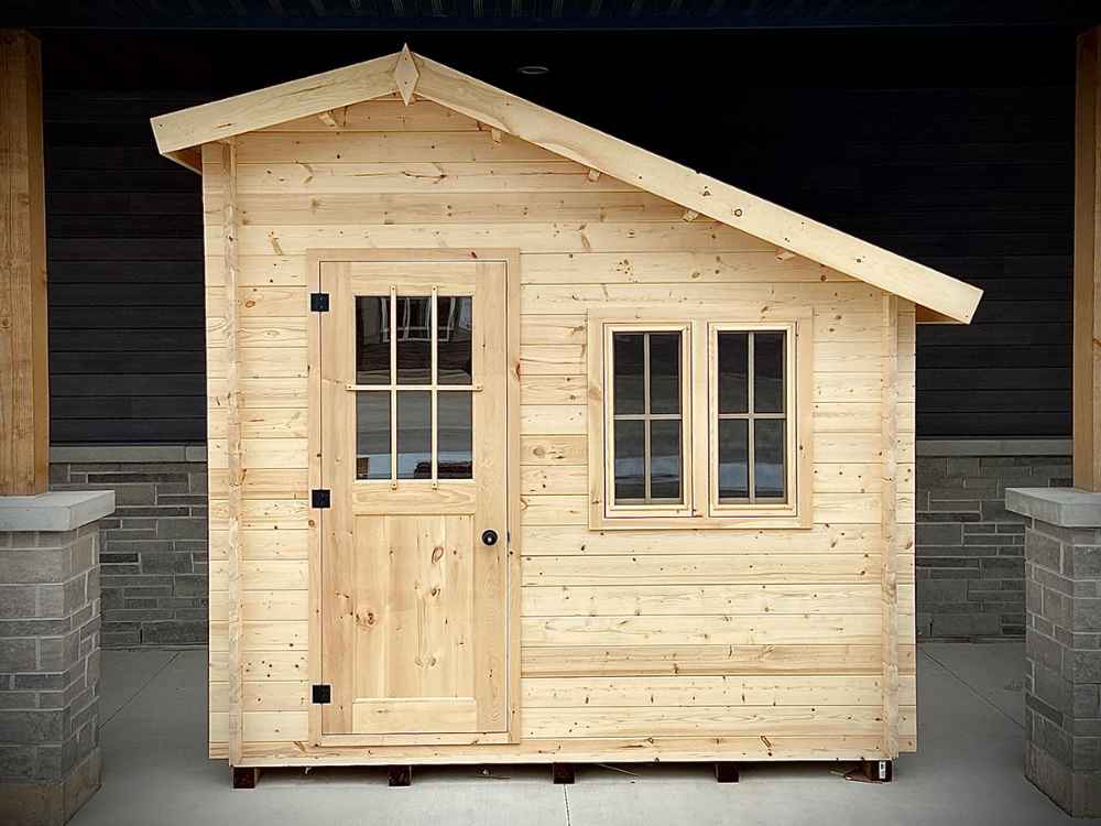 Front view of the Sawmill Structures Bluewater Den 67 Garden Room, clearly showing the centered door and two windows to the right