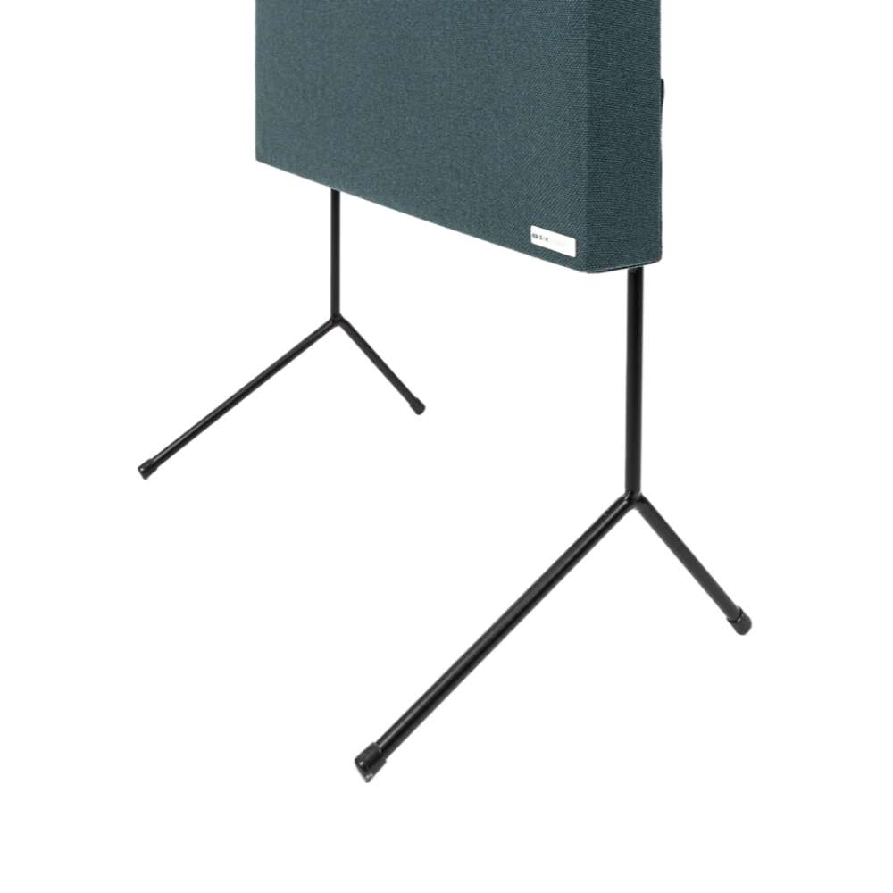 GIK Acoustics FlexRange Panel Stand close-up showing the teal acoustic panel’s lower corner, black metal legs, and wide tripod feet