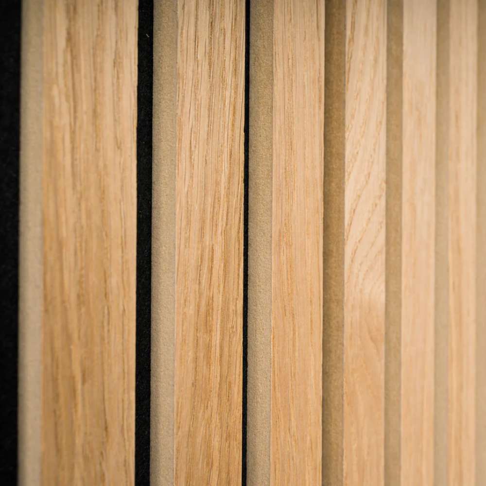 GIK Acoustics SlatFusor™ Corner Bass Trap shown in a detailed close-up highlighting vertical natural wood slats mounted over an acoustic backing