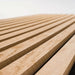 GIK Acoustics SlatFusor™ Corner Bass Trap viewed from a low angle, emphasizing the clean lines and depth of its evenly spaced wooden slats