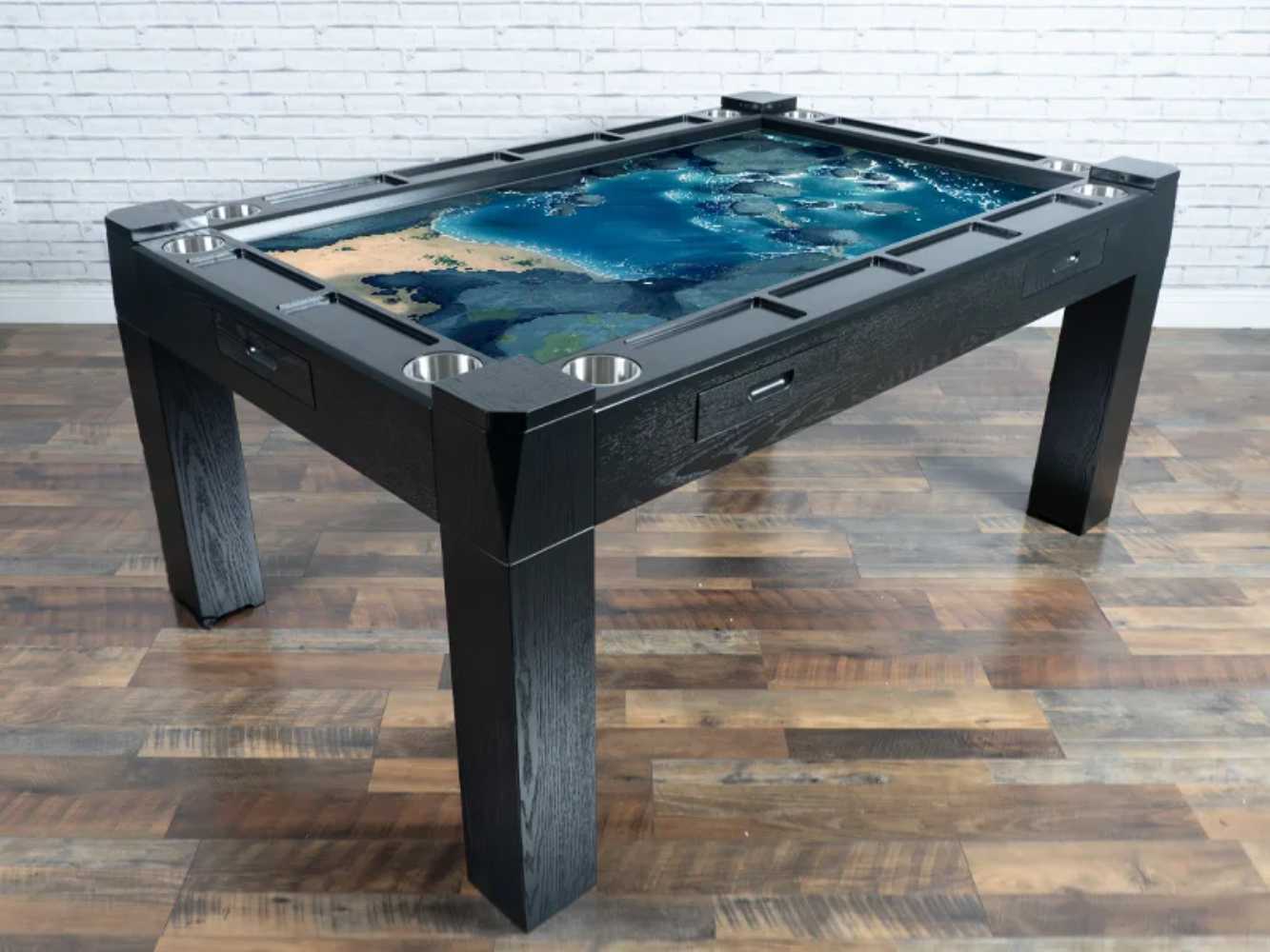 Game Theory Tables The Arena Founders Edition in a black finish provides a sleek, professional look with built-in cup holders and storage