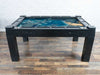 Game Theory Tables The Arena Founders Edition in black finish with a vibrant blue map on display, highlighting its large, recessed game surface