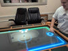 Game Theory Tables The Arena Founders Edition is shown with a touchscreen-like interactive display