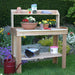 Garden display shows a potting bench with flowers and tools on grass, with Outdoor Living Today 4×2 Western Red Cedar Potting Bench at the center