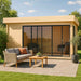 GardenHouse24 USA ALU Concept 70C Garden Room is styled with outdoor seating in front and warm lighting inside