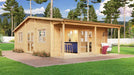 GardenHouse24 USA Bente 70 Garden Room with large windows and a stylish front porch nestled among tall pine trees