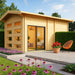 GardenHouse24 USA Caddie 70B ALU ISO Garden Room appears with large glass windows and a cozy patio featuring flowers and a bright orange chair