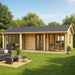 GardenHouse24 USA Casablanca 70 Garden Room with large glass doors and windows sits in a green backyard