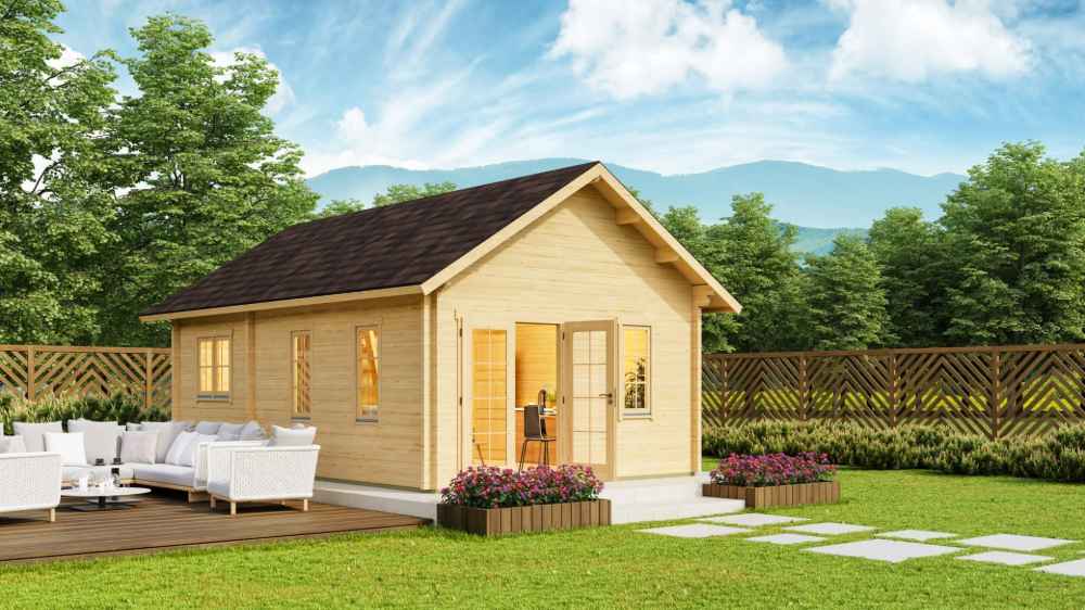 GardenHouse24 USA Farum 44 Garden Room is shown glowing warmly in a fenced backyard with a mountain view and cozy outdoor seating