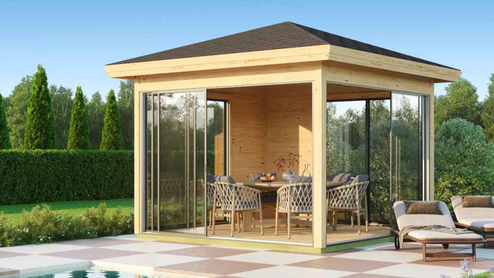 GardenHouse24 USA Glaspavillon ALU 44E ISO Garden Room features a stylish dining setup inside a sunlit glass pavilion near lounge chairs