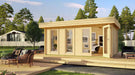 GardenHouse24 USA Miriam 44B Modern Garden Room is shown fully assembled in a lush outdoor setting with modern patio decor and art visible inside