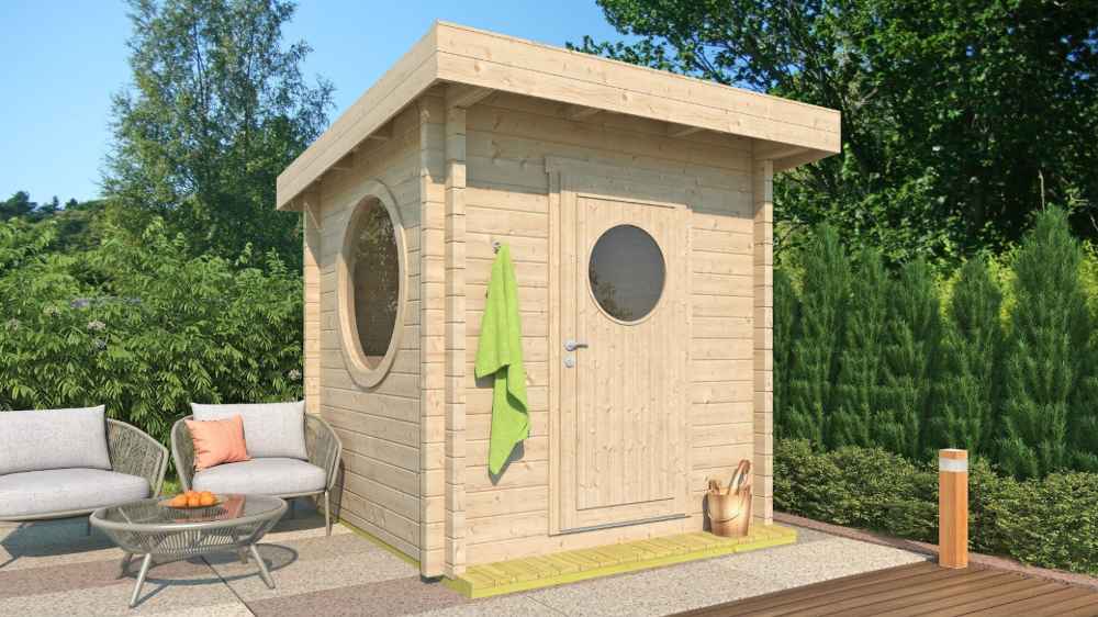 GardenHouse24 USA Sauna Maria 90 Garden Room sits on a sunny patio surrounded by greenery, with a towel hanging outside and round windows visible