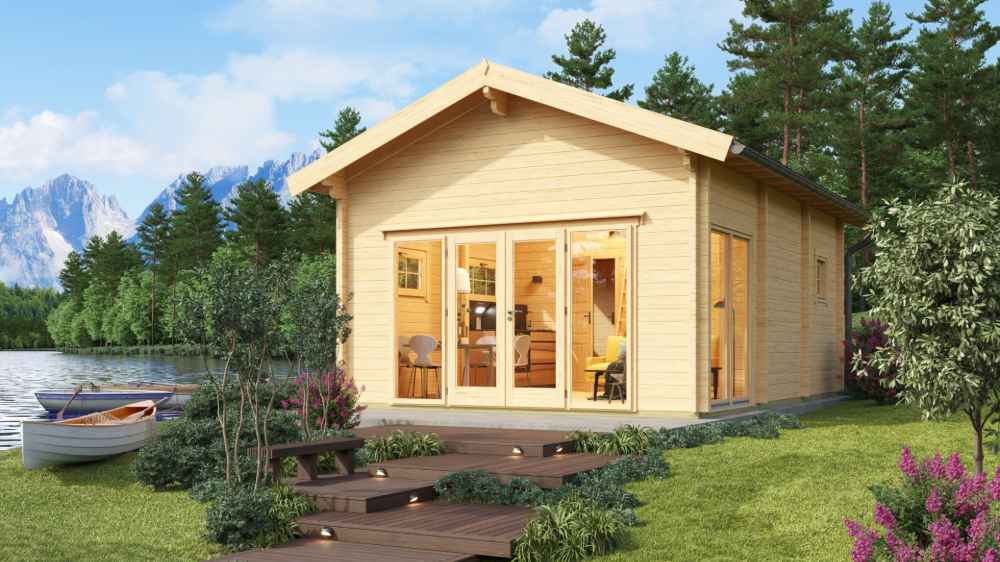 GardenHouse24 USA Sigrid 44 Garden Room is shown in a lakeside setting surrounded by trees and flowers, glowing warmly with interior lights